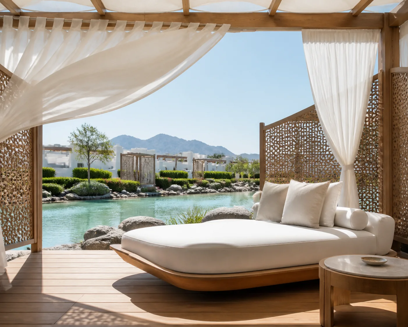 Private resort poolside cabana with curtained daybed, woven teak frame, and plush quick-dry cushions